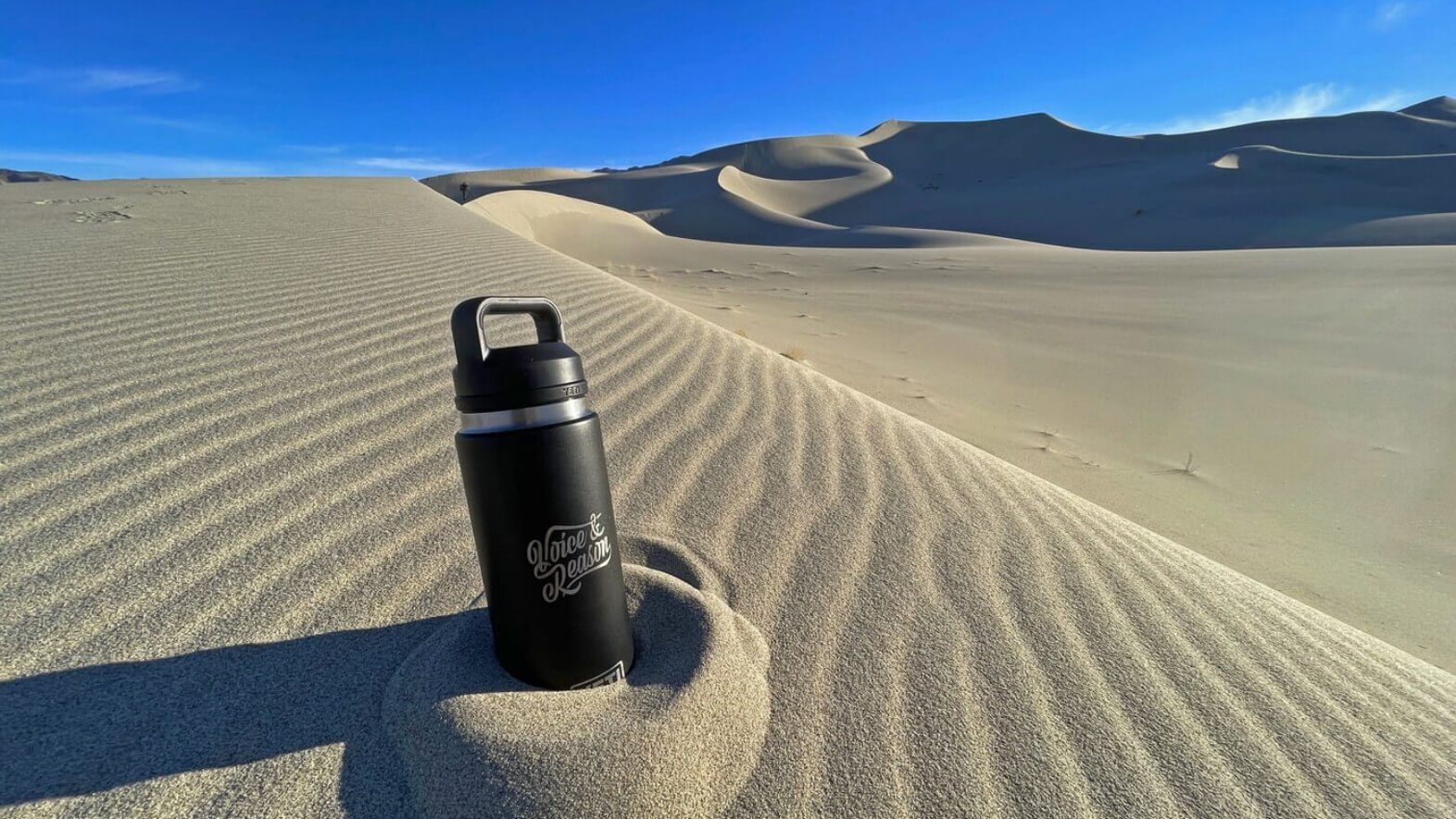 Voice & Reason water bottle in desert